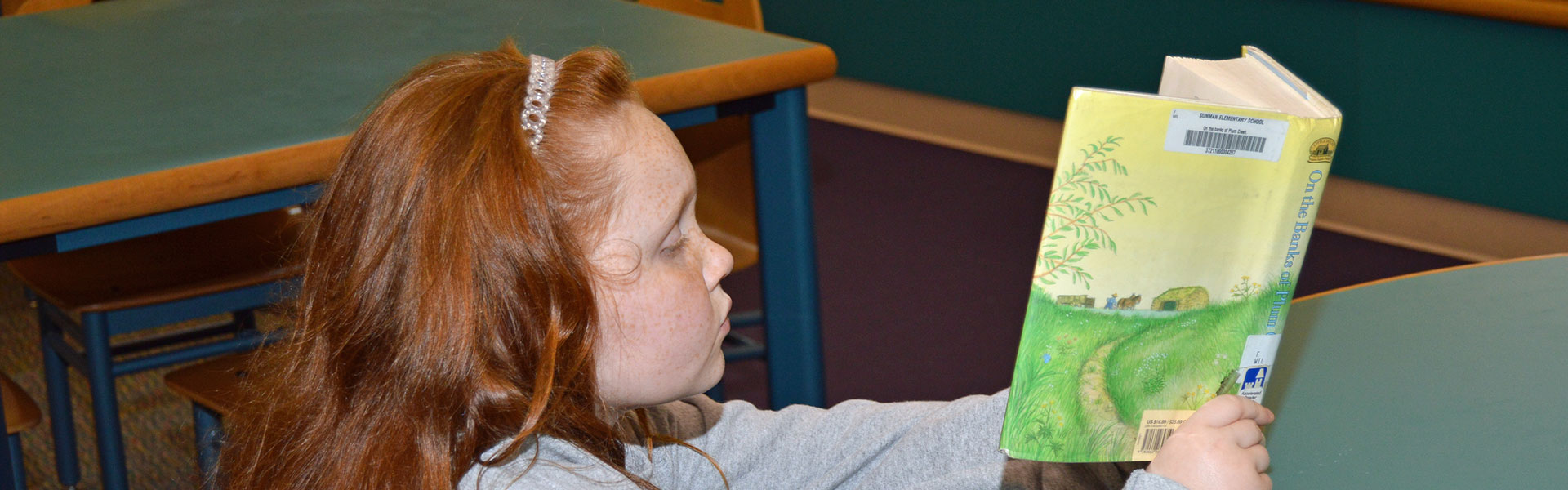 Sunman Elementary School Student Reading a Book